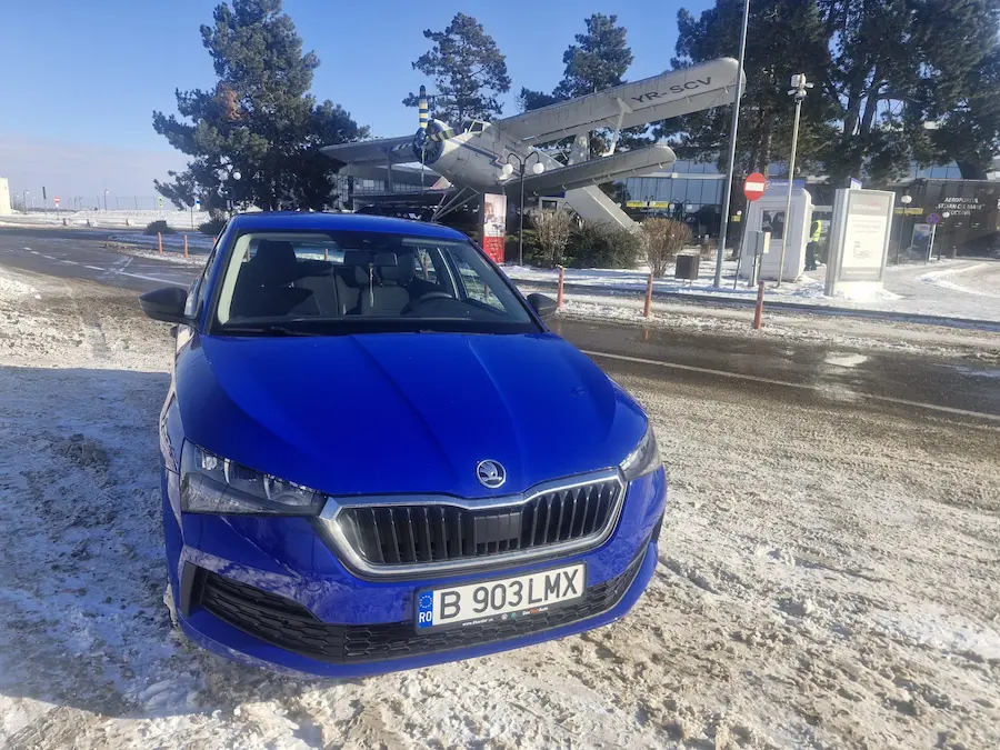 Skoda Scala rental car by Viocars parked in front of Suceava Airport